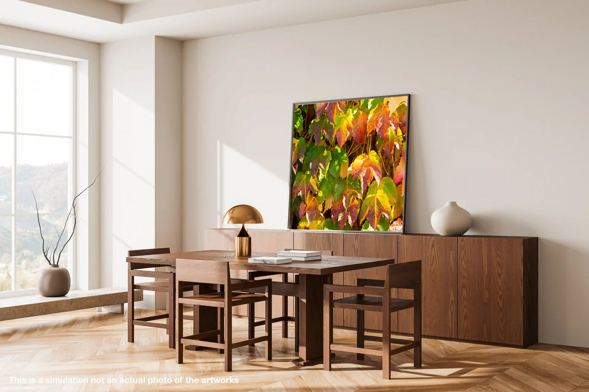 Dining room with wooden furniture and a large TV displaying colorful foliage.