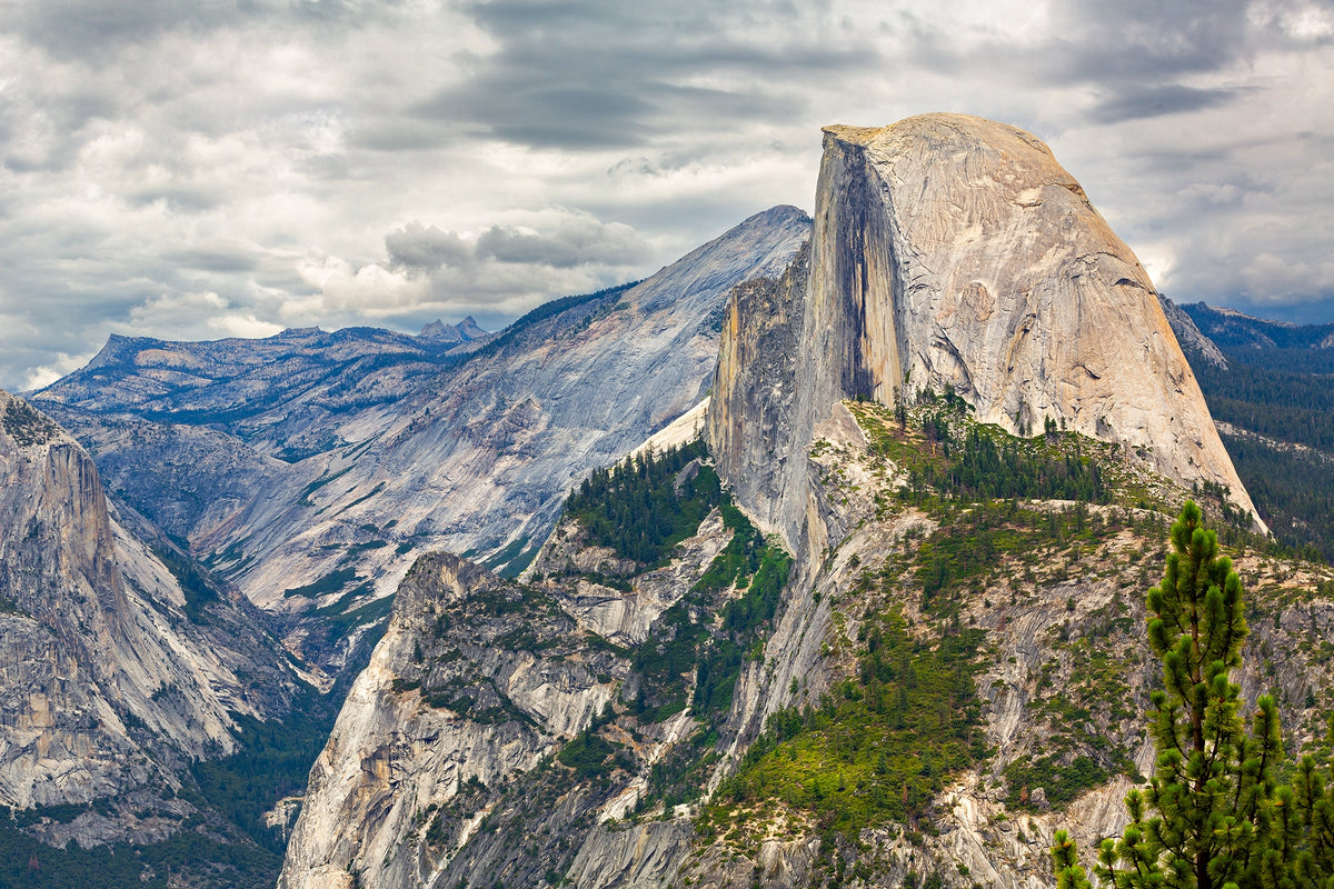 Mountain landscape with a prominent rocky peak under a cloudy sky